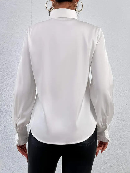 Stylish shirt with ruffled and layered design details.